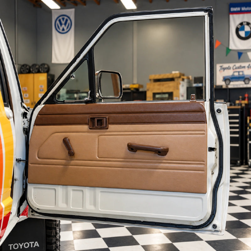 An open Toyota door showing the restored tan door panel with a brown upper section and brown handles